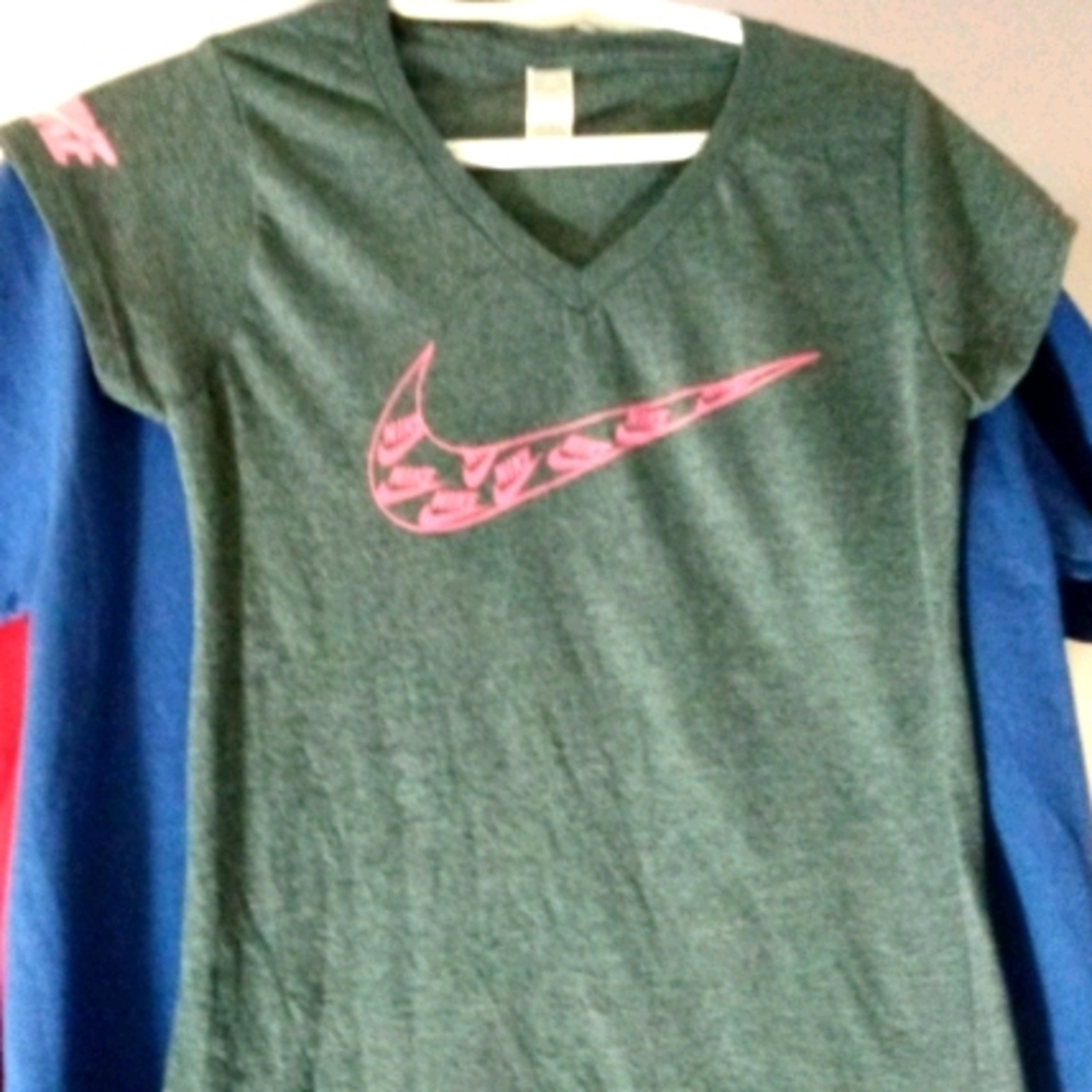 Pink Nike swoosh on front, logo on sleeve, small